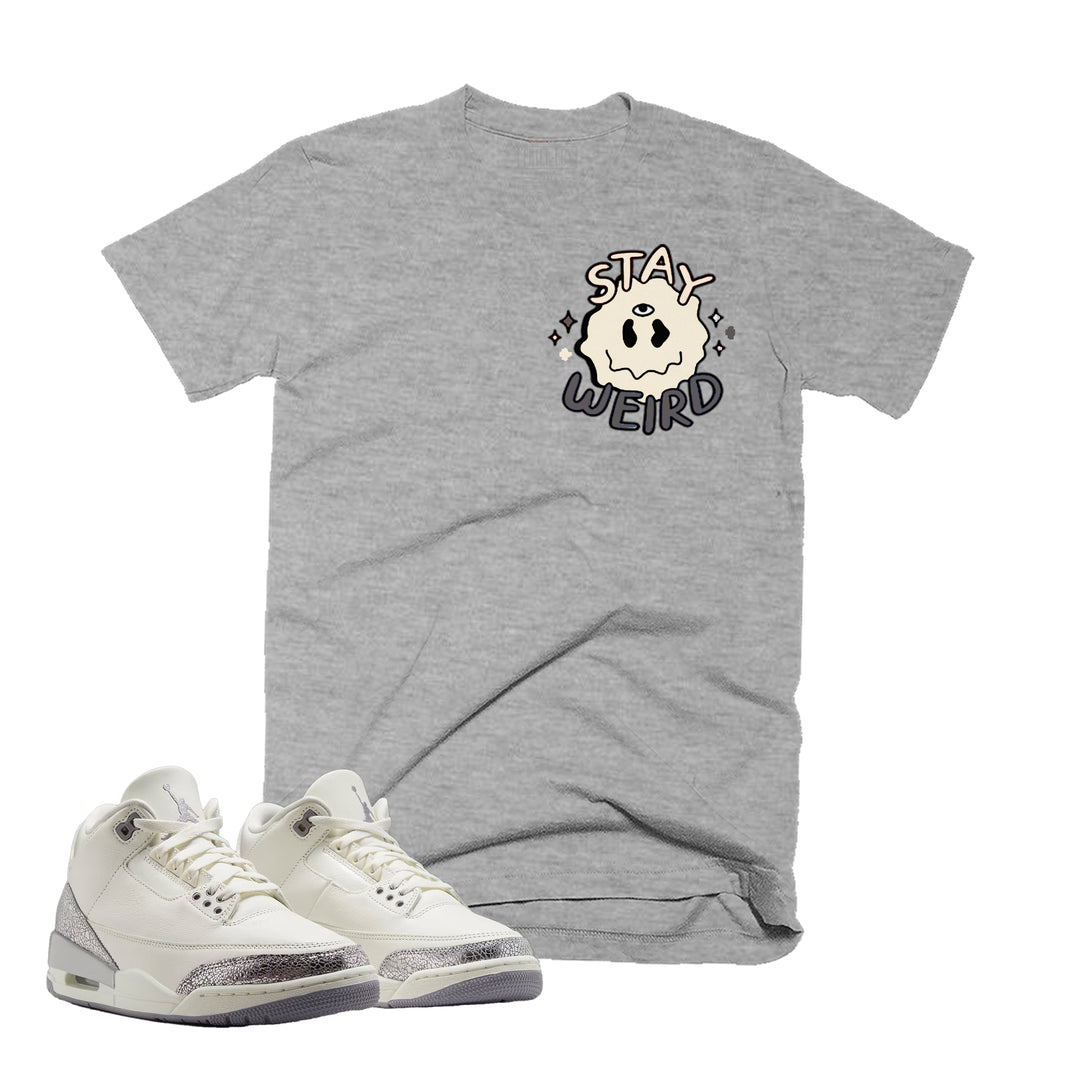Heather Grey T-shirt with an stay weird design on the front