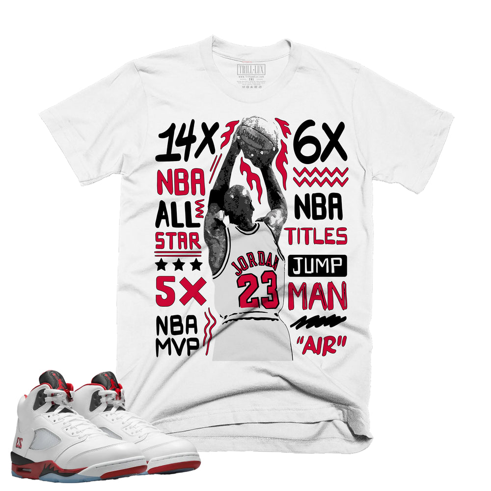 White t-shirt with sports-themed graphics and text, paired with white sneakers.
